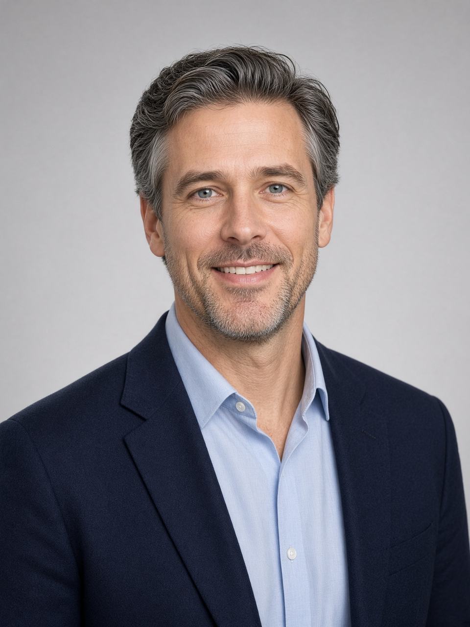Consultant-style headshot in a navy blazer